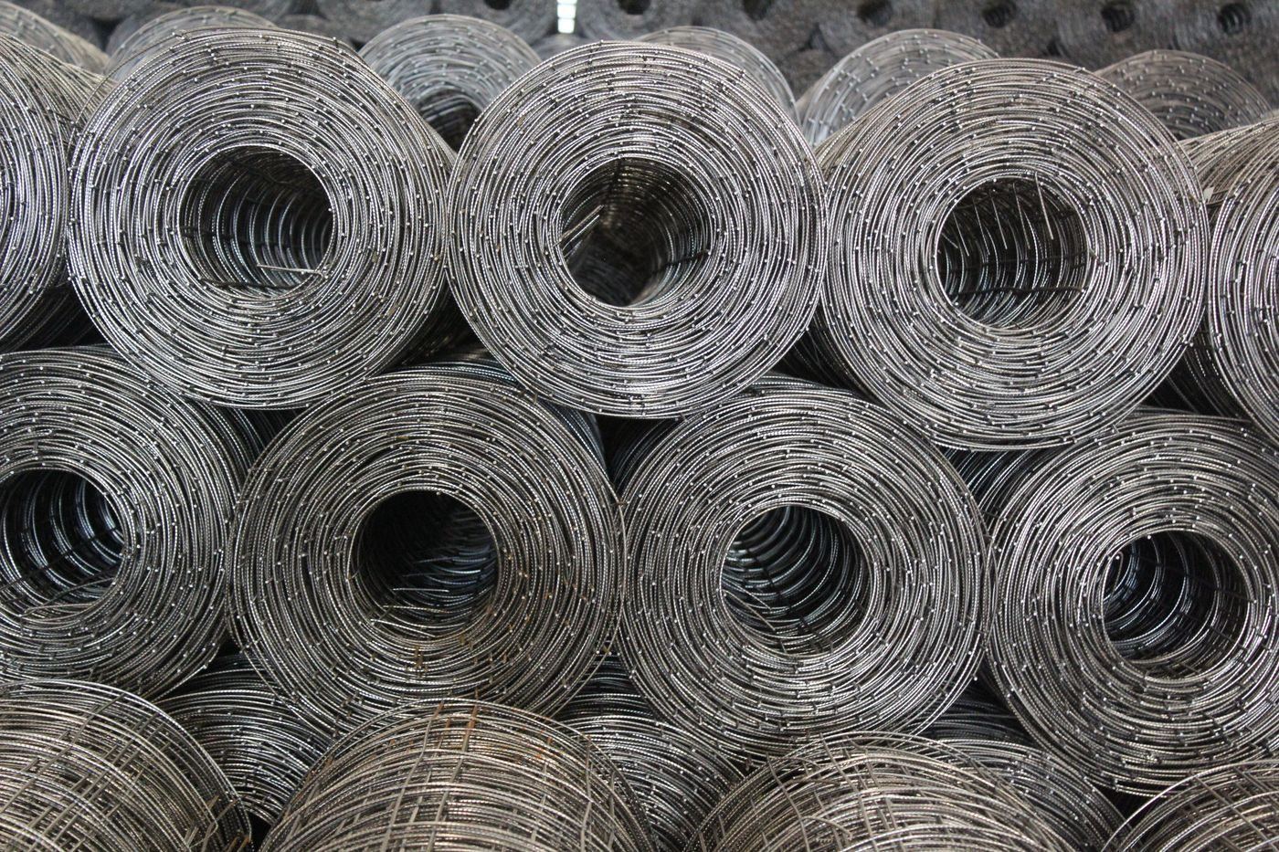Rolls of steel wire mesh reinforcement stored at a supplier yard