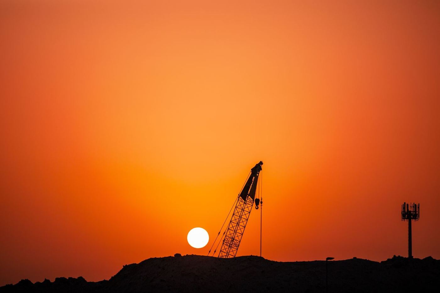 Crane silhouette against a sunset sky