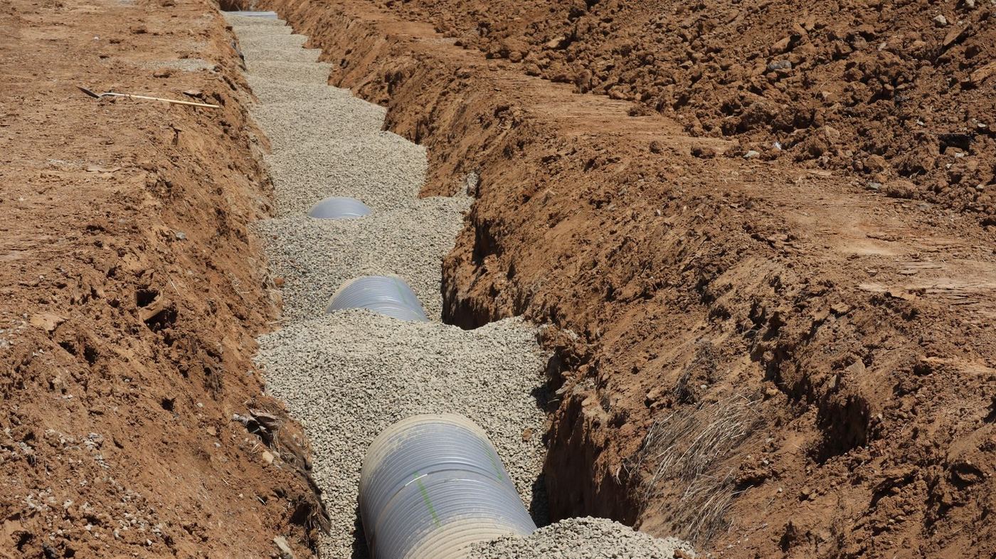 RC pipes bedded into a drainage trench on site