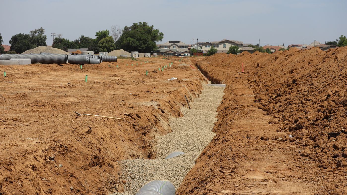 RC pipes bedded into a drainage trench on a Johor site